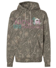 Load image into Gallery viewer, A camouflage pullover hoodie with a woodland branch and leaf pattern in shades of brown, gray, and green. It features a drawstring hood, a kangaroo pocket, and a chest graphic with the text 'COCHRAN &amp; CO LEAF STORE' and a house icon.
